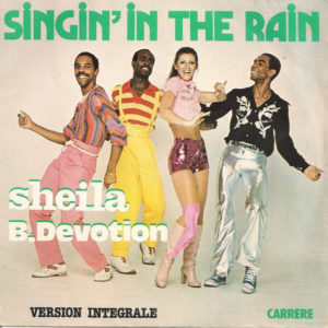 SHEILA B. DEVOTION – Singin’ In The Rain